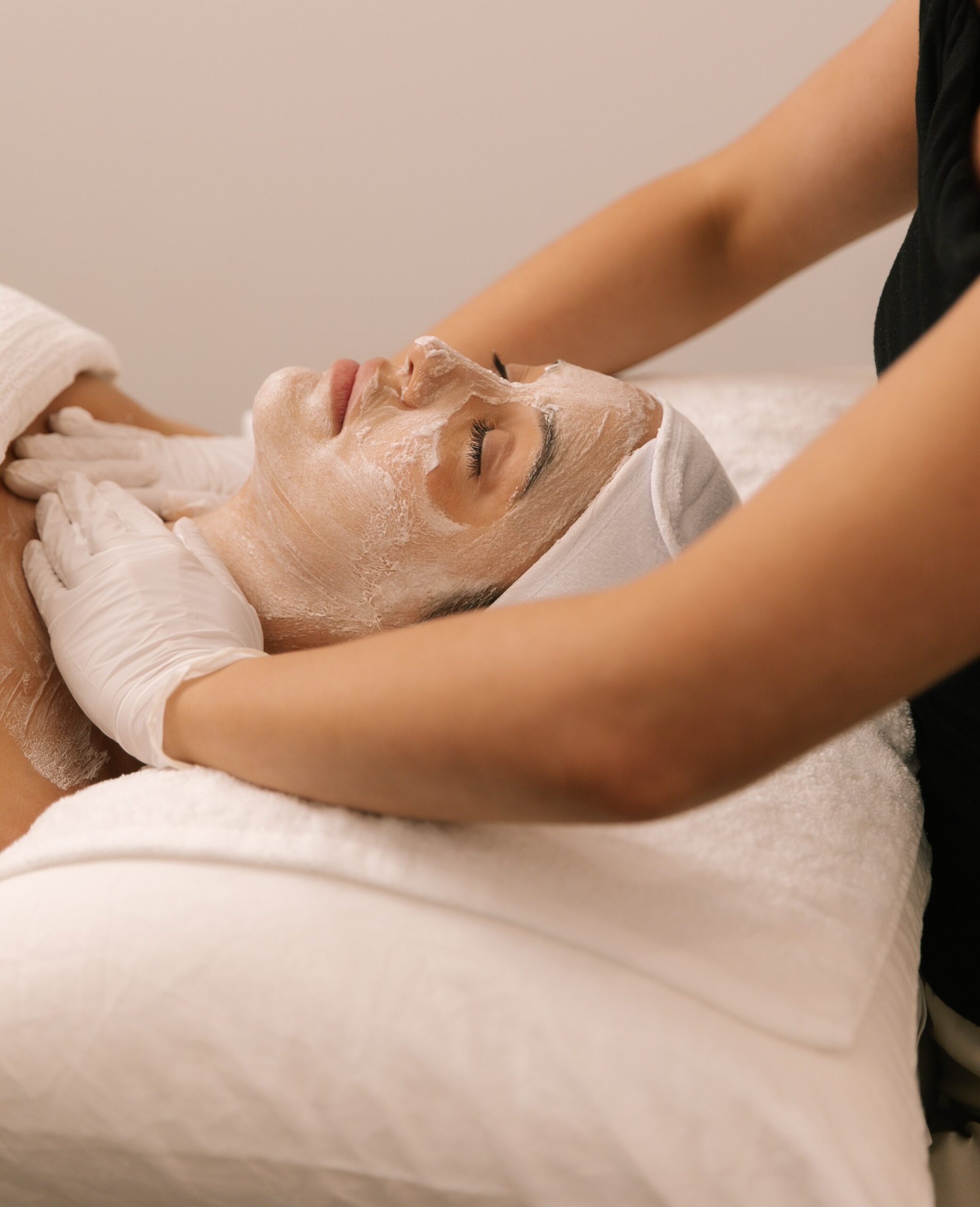 Dermal clinician applying a treatment mask during a staged acne facial at Plump Aesthetic Clinic South Yarra