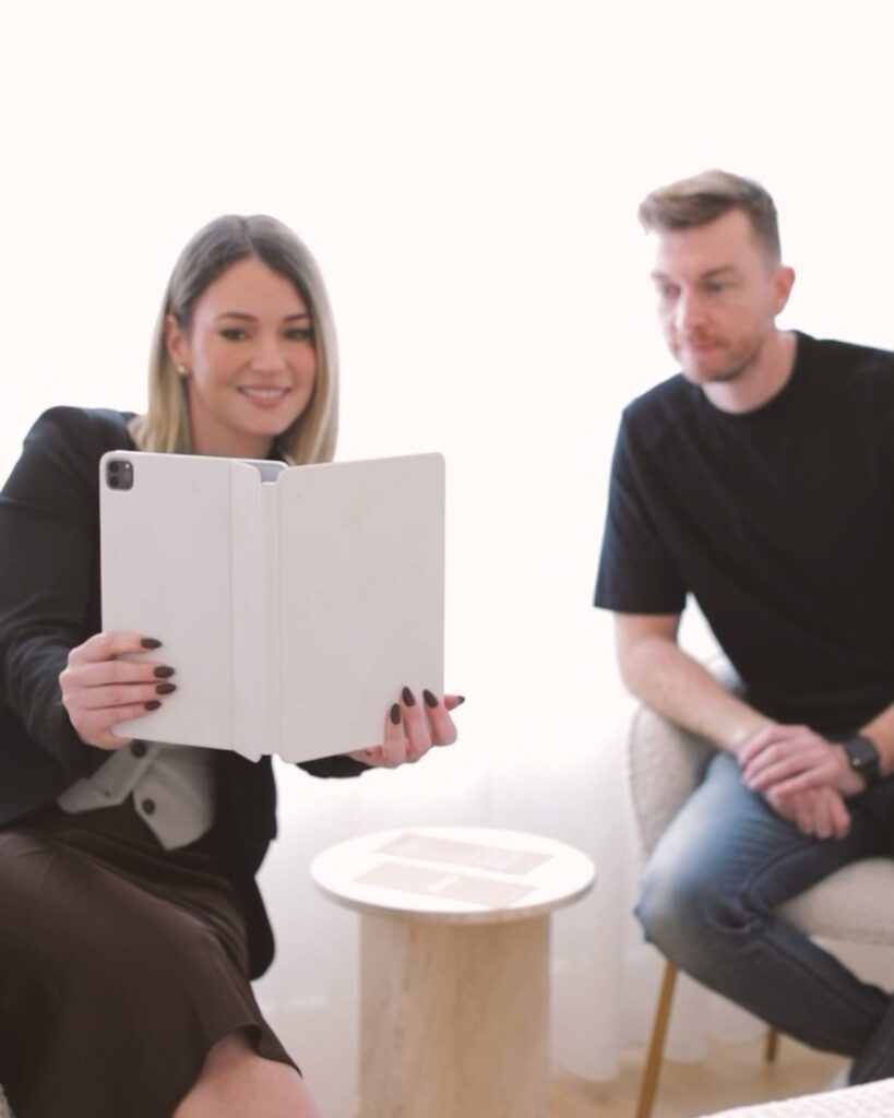 Nurse Caitlin talking a client through treatment options on an iPad during a consultation at Plump Aesthetic Clinic in South Yarra.