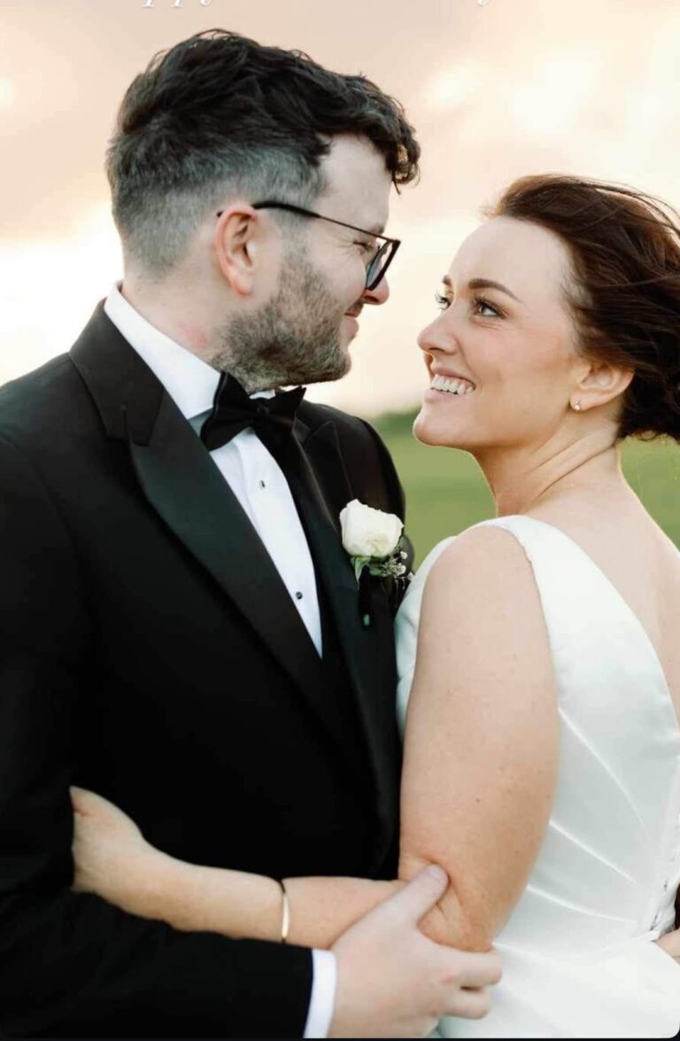 Bride and groom embracing at golden hour